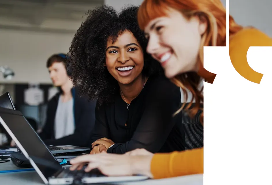 Business professionals collaborating around a laptop